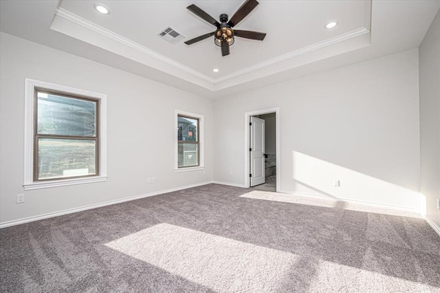 unfurnished bedroom with crown molding, carpet flooring, and a raised ceiling