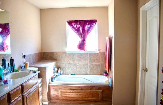 full bath with a garden tub and a sink