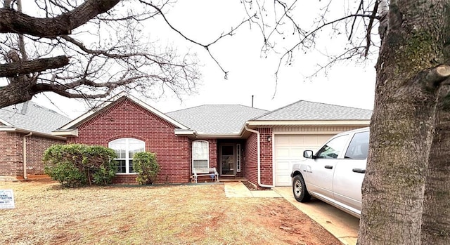 ranch-style house featuring brick siding, a front lawn, a shingled roof, and a garage