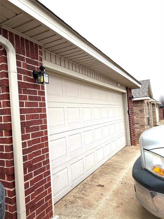 garage featuring concrete driveway