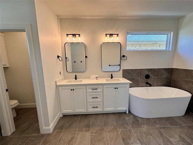 12812 Cobblestone Curve Rd, Oklahoma City, OK 73142 - full bathroom featuring a soaking tub, a sink, double vanity, and toilet