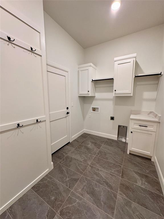 12812 Cobblestone Curve Rd, Oklahoma City, OK 73142 - washroom with marble finish floor, baseboards, electric dryer hookup, cabinet space, and washer hookup