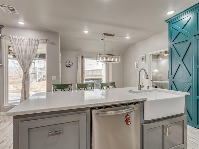 kitchen with recessed lighting, visible vents, stainless steel dishwasher, a sink, and an island with sink