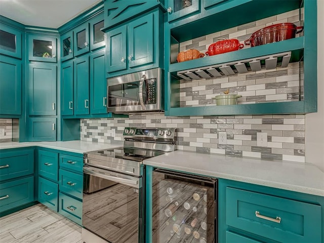 kitchen featuring wine cooler, appliances with stainless steel finishes, open shelves, and light countertops