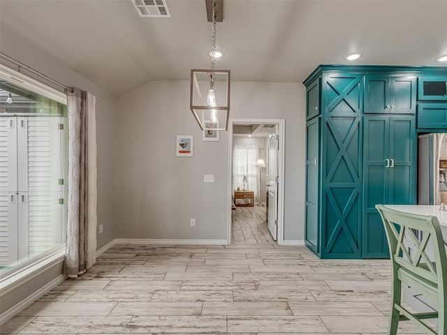 interior space with baseboards, visible vents, vaulted ceiling, wood finish floors, and recessed lighting