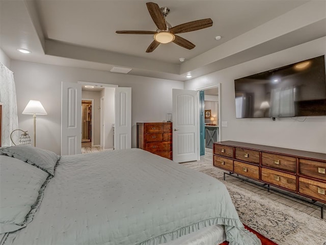 bedroom featuring a tray ceiling and ceiling fan