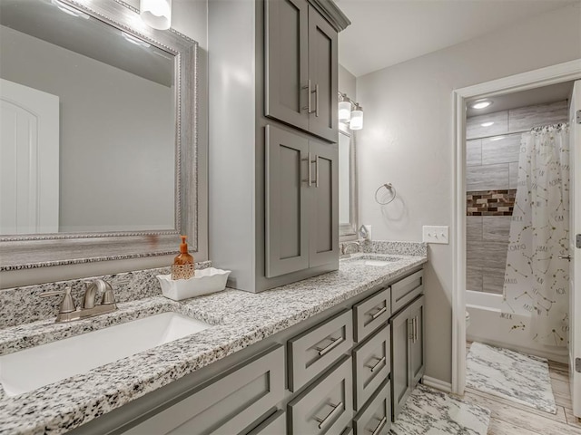 bathroom with double vanity, toilet, a sink, and shower / tub combo with curtain