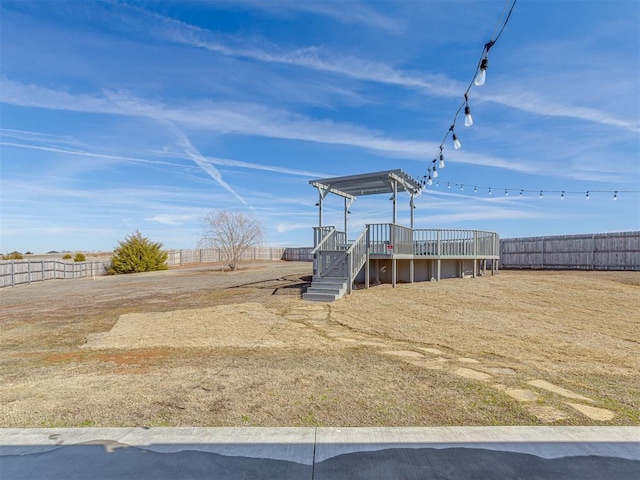 view of yard featuring a deck and fence