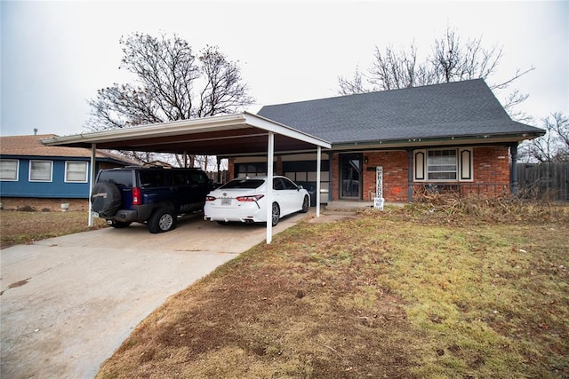 view of front of home with a front yard and a carport