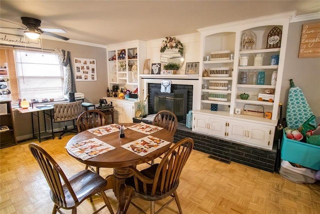 dining space featuring ceiling fan, crown molding, and light parquet floors