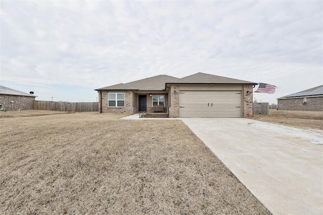 ranch-style home featuring brick siding, driveway, an attached garage, and fence