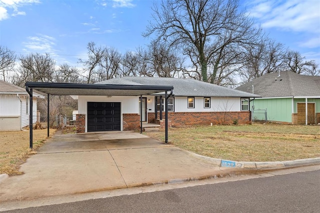 view of front of property featuring a carport, a garage, and a front yard