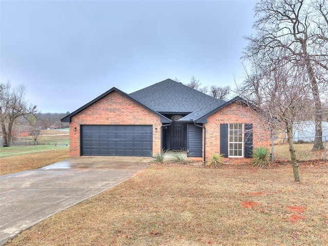 view of front of house with a garage and a front lawn