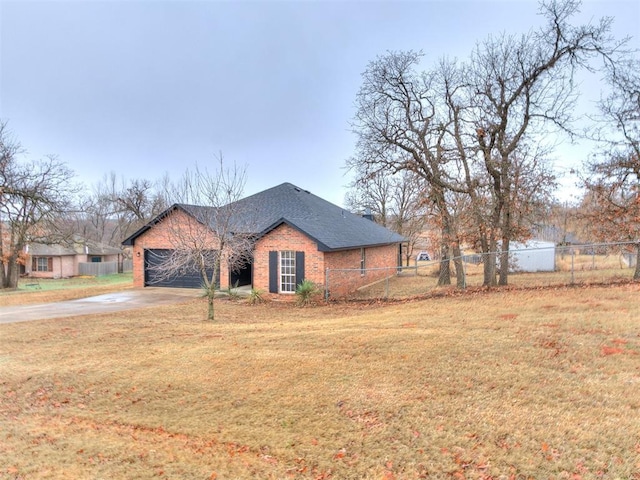 view of front of home with brick siding, fence, driveway, roof with shingles, and a front lawn