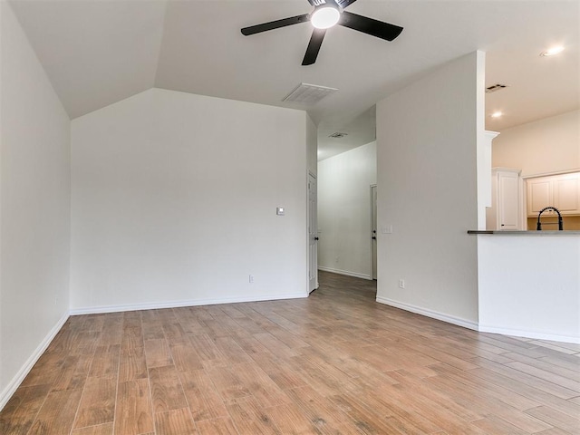 unfurnished living room with light wood-style flooring, visible vents, ceiling fan, and baseboards