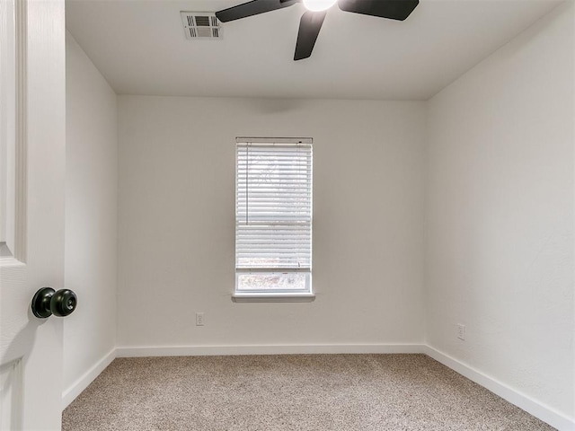 empty room featuring carpet, visible vents, and baseboards