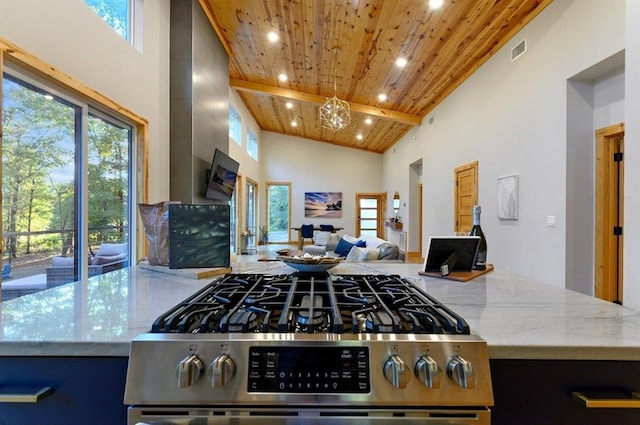 639 Woodland Hills Trl, Broken Bow, OK 74728 - kitchen featuring gas range, wood ceiling, light stone countertops, and high vaulted ceiling