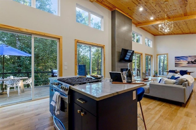 639 Woodland Hills Trl, Broken Bow, OK 74728 - kitchen featuring wood ceiling, stainless steel range with gas stovetop, light hardwood / wood-style flooring, and pendant lighting