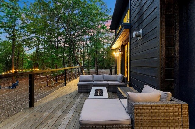 639 Woodland Hills Trl, Broken Bow, OK 74728 - deck at dusk featuring an outdoor living space
