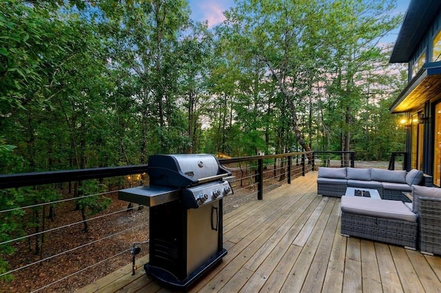 639 Woodland Hills Trl, Broken Bow, OK 74728 - deck at dusk featuring grilling area and outdoor lounge area