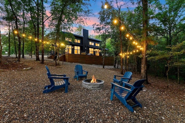 639 Woodland Hills Trl, Broken Bow, OK 74728 - playground at dusk with a fire pit