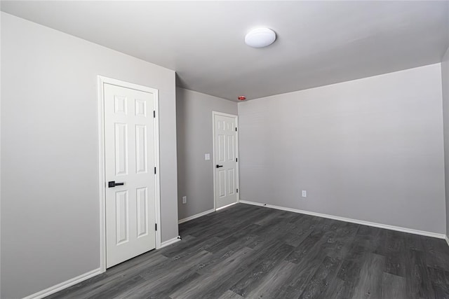 unfurnished room featuring dark wood-type flooring