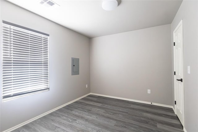 unfurnished room with dark wood-type flooring and electric panel