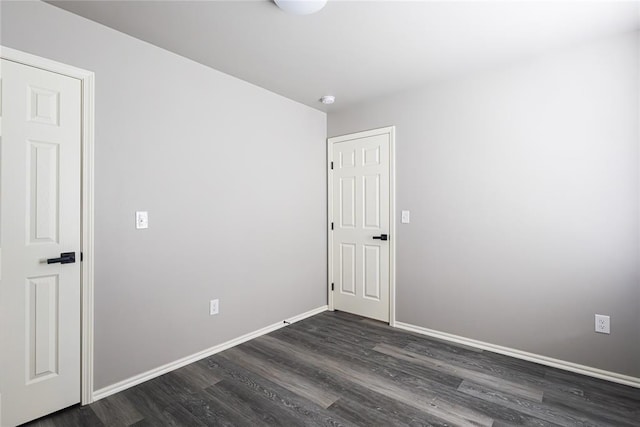 spare room with dark hardwood / wood-style flooring