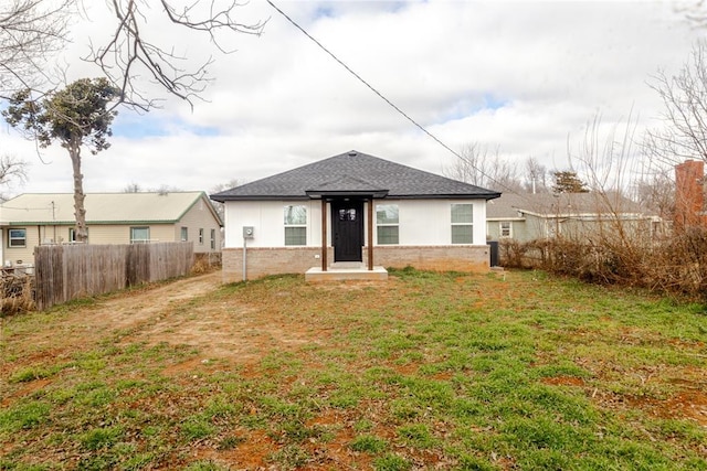 rear view of property featuring a lawn