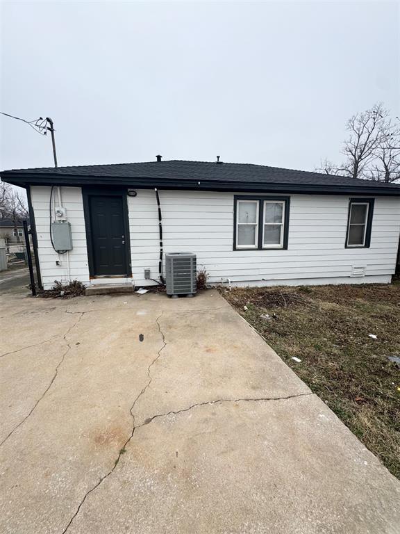 rear view of property featuring cooling unit and a patio area