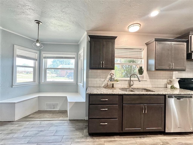 kitchen featuring decorative light fixtures, dishwasher, sink, light stone counters, and dark brown cabinets