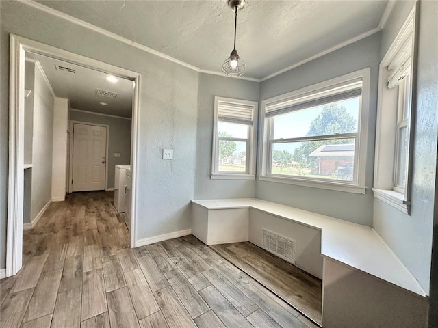 interior space with crown molding and light hardwood / wood-style floors