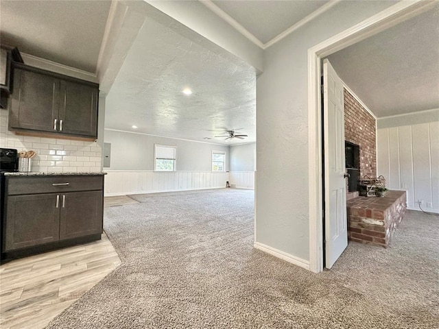 living room featuring a textured ceiling, light colored carpet, and ceiling fan