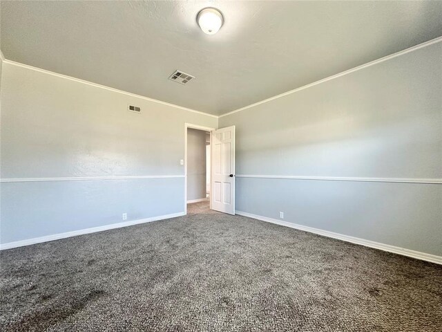 spare room featuring crown molding and carpet flooring