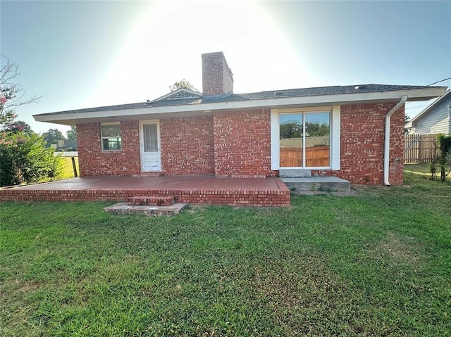 rear view of house with a yard and a deck