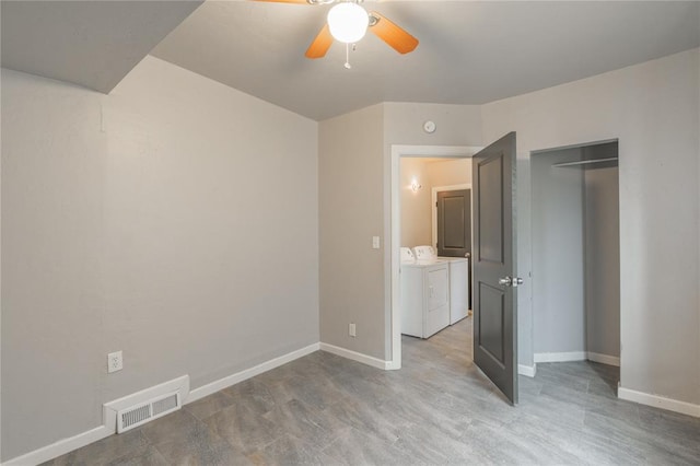 unfurnished bedroom with a closet, washer and dryer, and ceiling fan