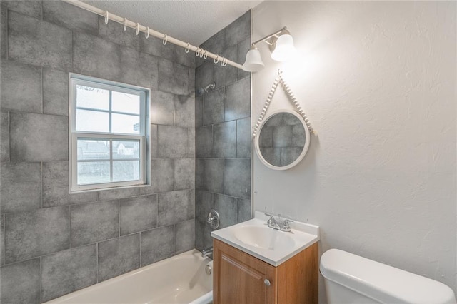 full bathroom featuring tiled shower / bath combo, vanity, and toilet