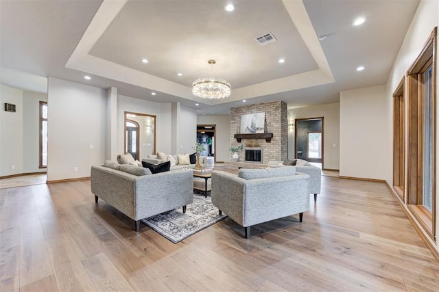 10401 Fawn Trace Rd, Mustang, OK 73064 - living room with a chandelier, light wood-style floors, a tray ceiling, baseboards, and recessed lighting