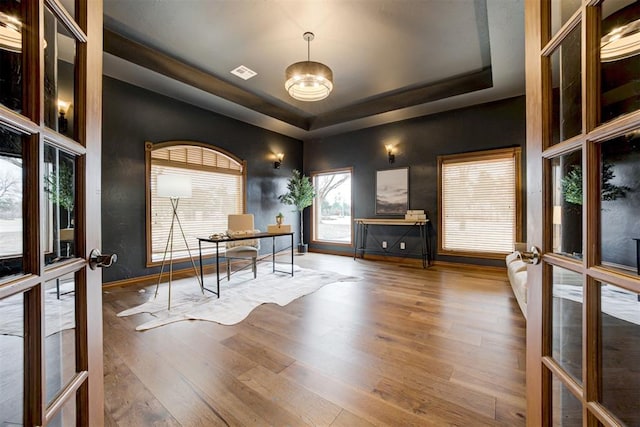 10401 Fawn Trace Rd, Mustang, OK 73064 - office space with visible vents, baseboards, wood finished floors, and a tray ceiling