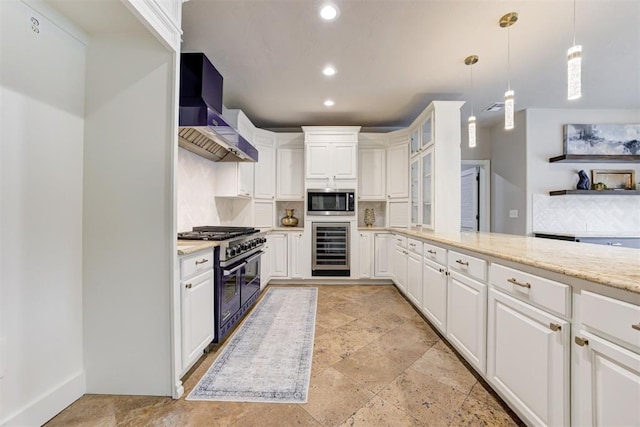 10401 Fawn Trace Rd, Mustang, OK 73064 - kitchen featuring recessed lighting, wine cooler, stainless steel microwave, wall chimney exhaust hood, and double oven range