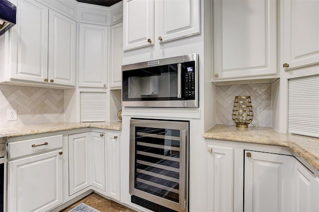 10401 Fawn Trace Rd, Mustang, OK 73064 - interior space with stainless steel microwave, backsplash, and wine cooler