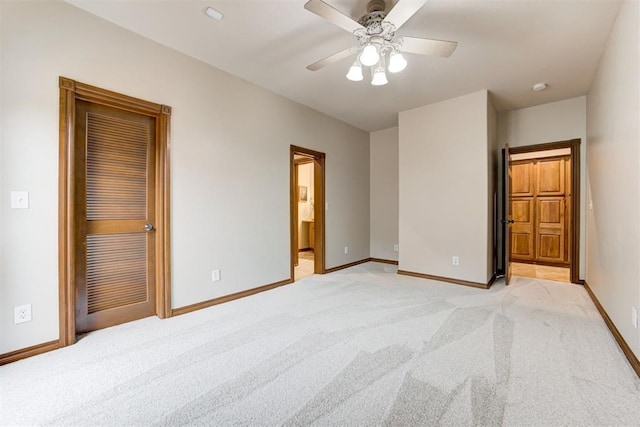 10401 Fawn Trace Rd, Mustang, OK 73064 - unfurnished bedroom featuring baseboards, ensuite bath, light colored carpet, and ceiling fan