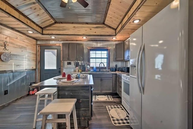 kitchen featuring lofted ceiling, white appliances, wooden ceiling, and a center island