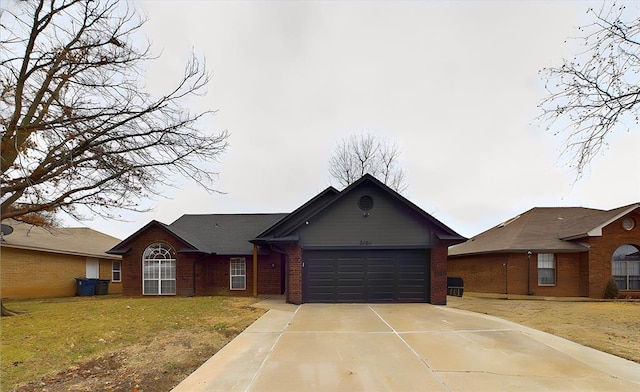 ranch-style home featuring a garage and a front lawn