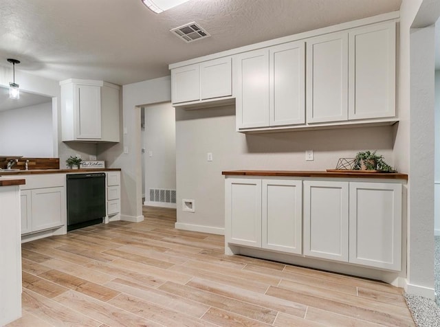 kitchen with white cabinetry, dishwasher, pendant lighting, and light hardwood / wood-style floors