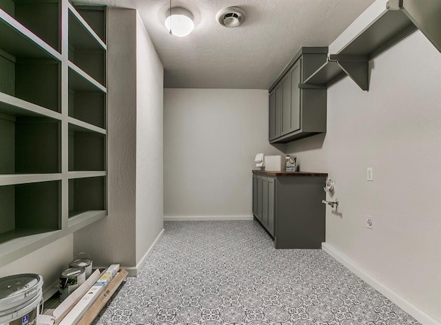 laundry area featuring a textured ceiling