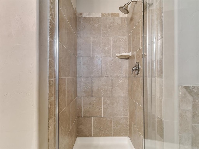 bathroom with a tile shower