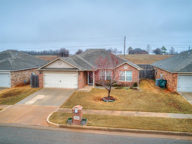 ranch-style home with a garage and a front lawn