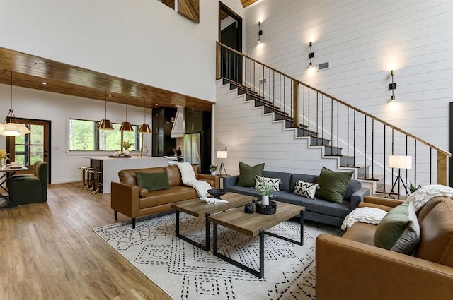 living room with a high ceiling and light wood-type flooring