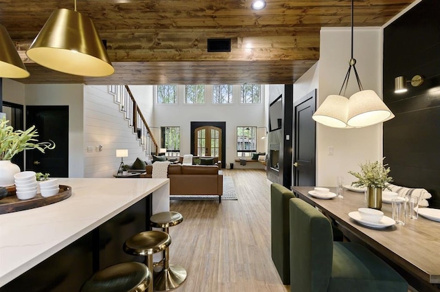 dining room with wood ceiling and wood-type flooring